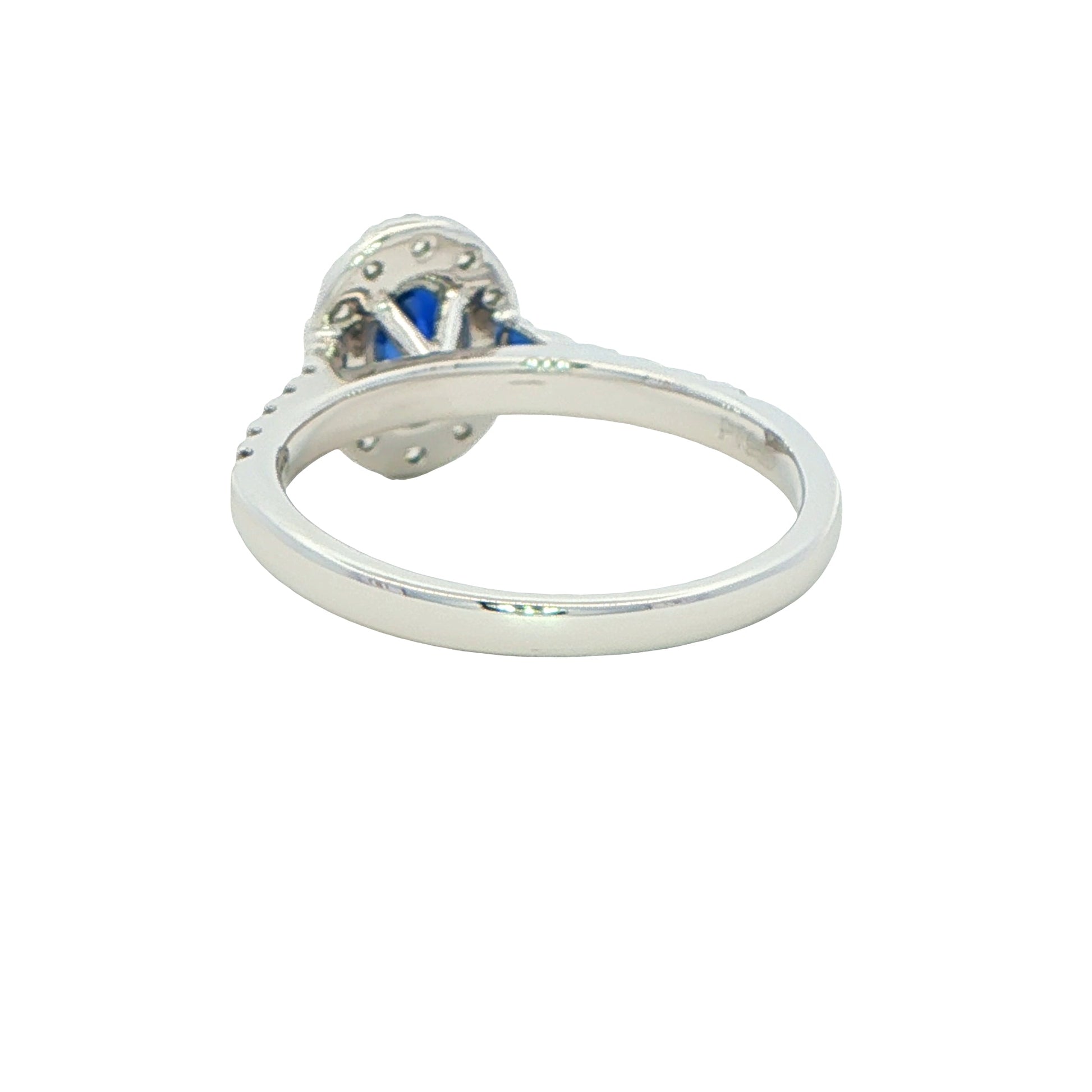 Oval shaped sapphire and round brilliant cut diamond halo style ring Gardiner Brothers