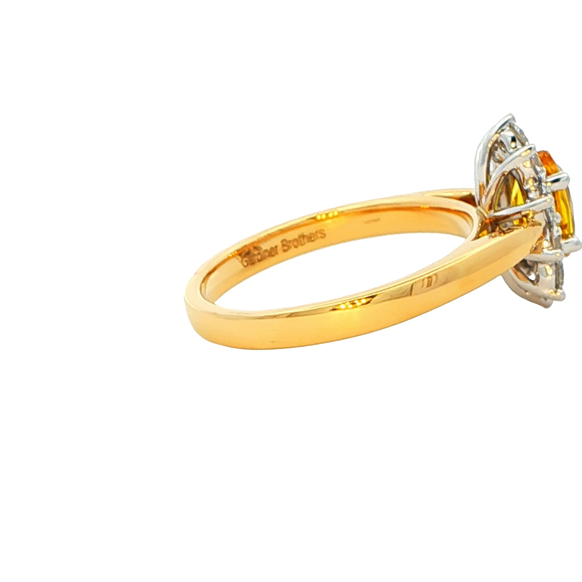 Oval Shaped Yellow Sapphire and round brilliant cut diamond cluster ring Gardiner Brothers