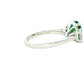 Cushion shaped emerald and round brilliant cut diamond 3 stone ring Gardiner Brothers