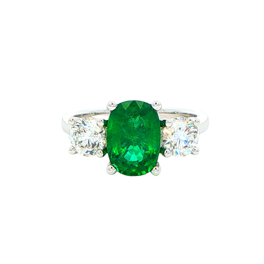 Cushion shaped emerald and round brilliant cut diamond 3 stone ring Gardiner Brothers