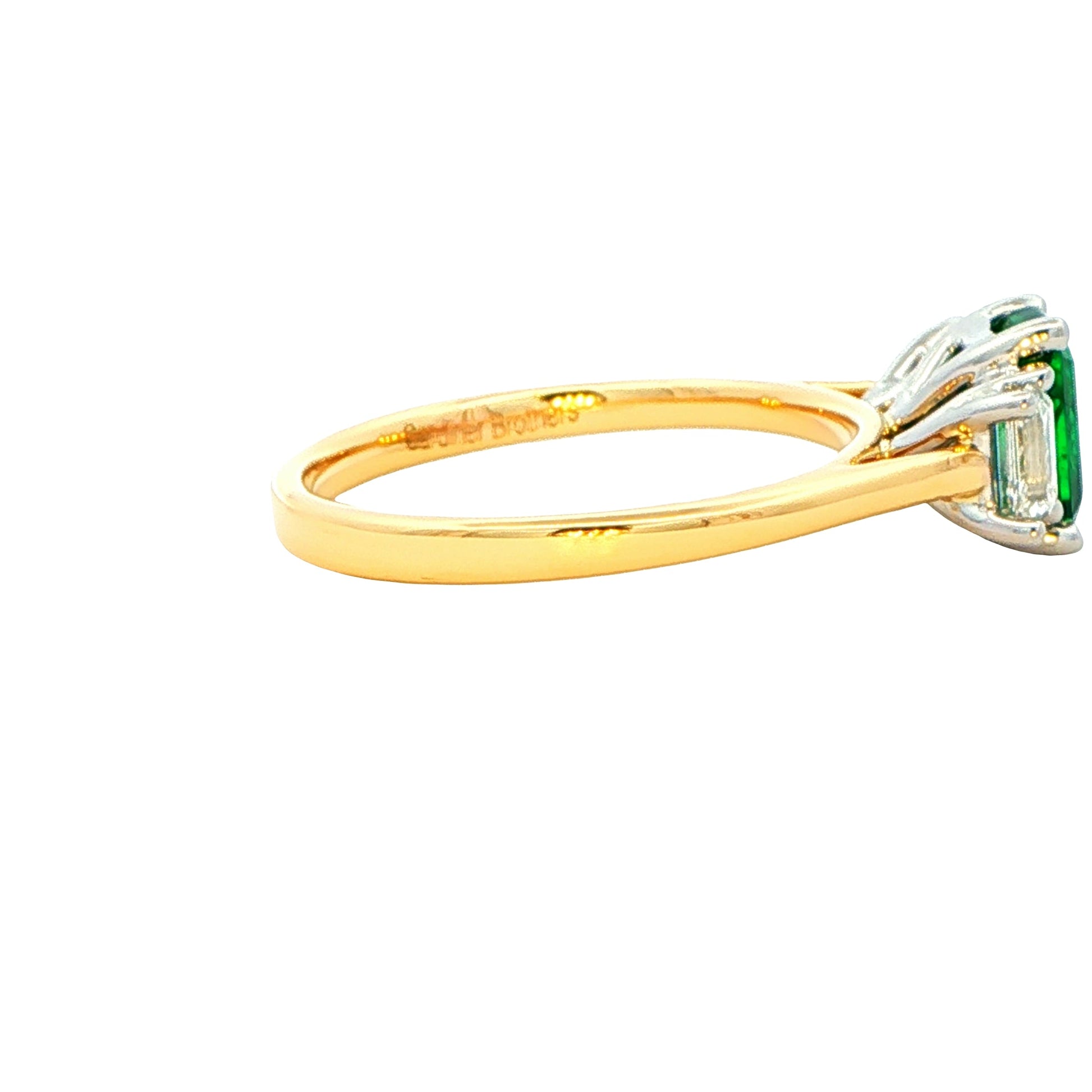 Octagonal shaped emerald and emerald cut diamond 3 stone ring Gardiner Brothers