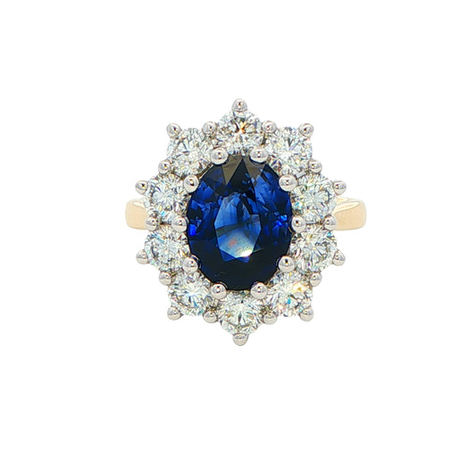 Oval shaped Sapphire and 10 round brilliant cut diamond cluster style ring Gardiner Brothers