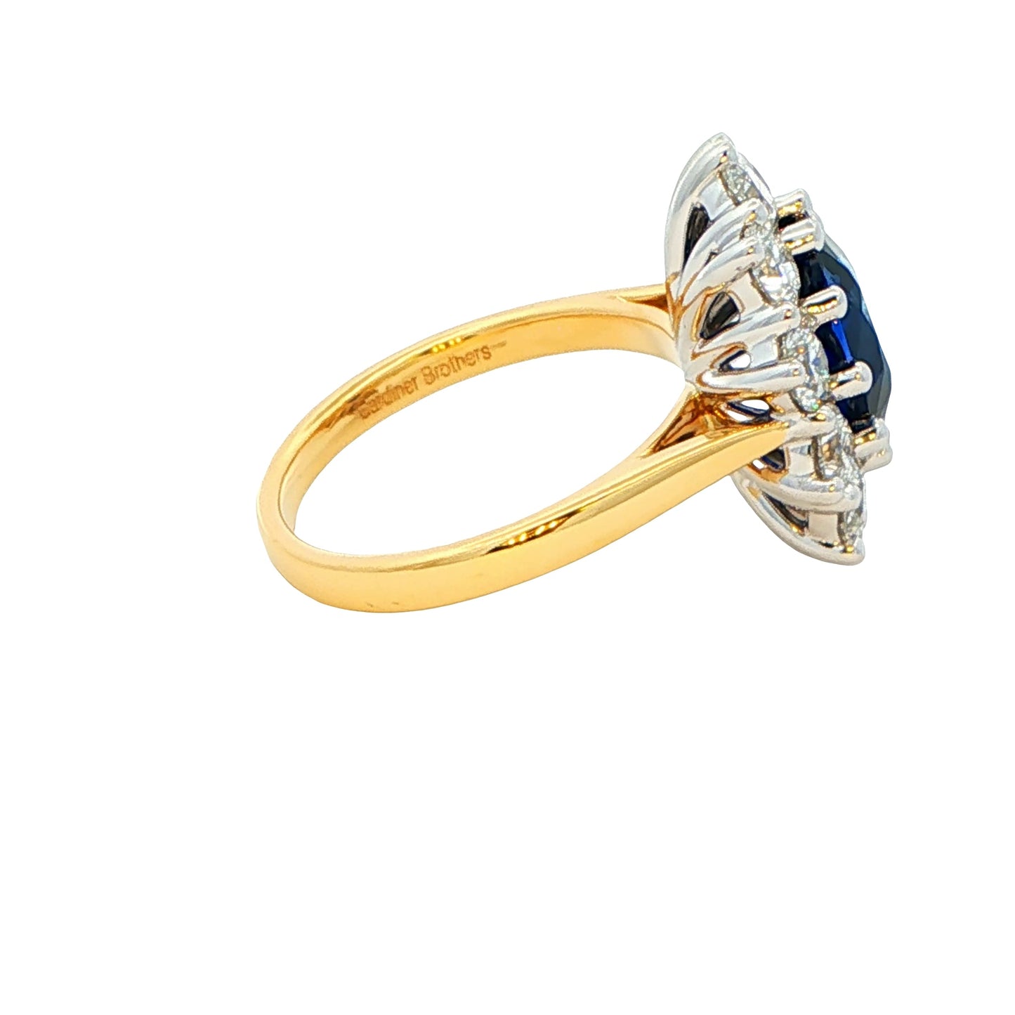 Oval shaped Sapphire and 10 round brilliant cut diamond cluster style ring Gardiner Brothers