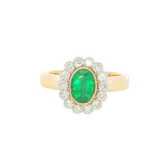 Oval emerald and round brilliant cut diamond vintage style cluster ring