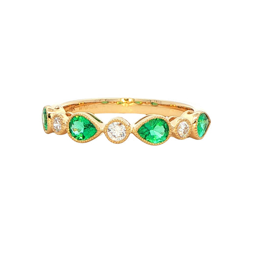 Pear shaped emerald and round brilliant cut diamond dress ring