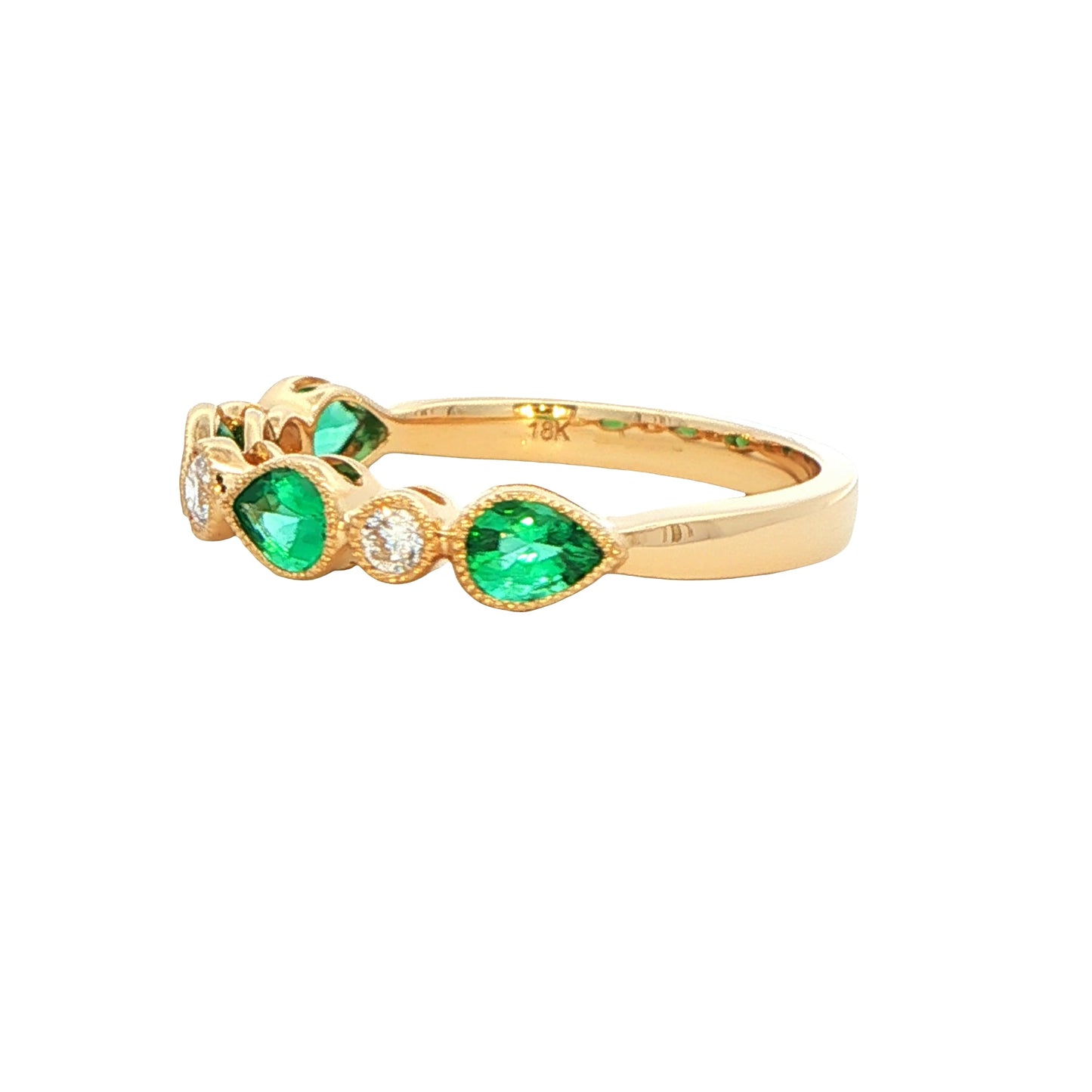 Pear shaped emerald and round brilliant cut diamond dress ring