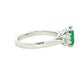 Octagonal shaped emerald and round brilliant cut diamond 3 stone ring Gardiner Brothers