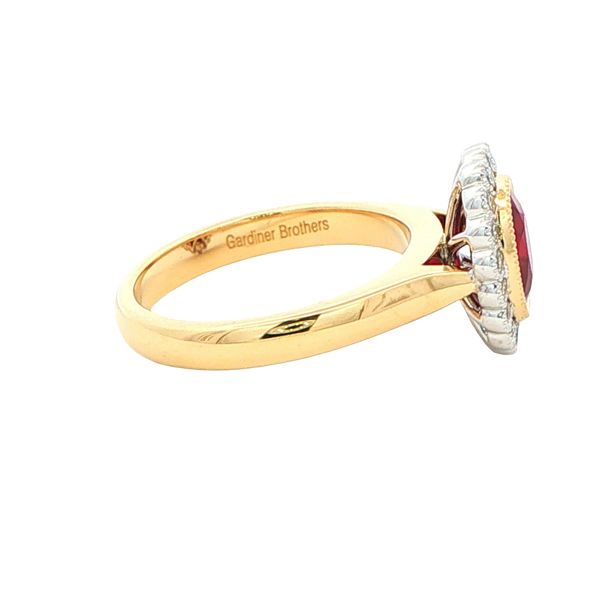 Oval ruby and round brilliant cut diamond vintage style cluster ring Gardiner Brothers