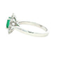 Octagonal shaped emerald and round brilliant cut diamond cluster style ring