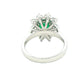 Octagonal shaped emerald and round brilliant cut diamond cluster style ring
