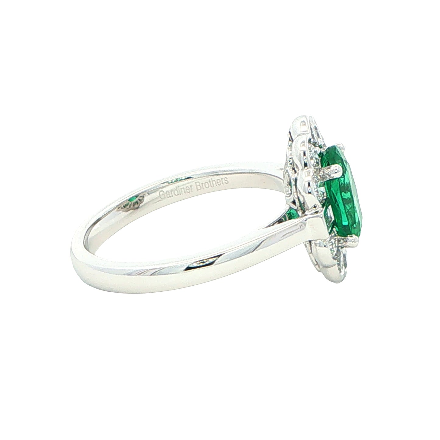 Oval emerald and diamond fancy cluster style ring