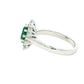 Emerald and round brilliant cut diamond cluster style ring