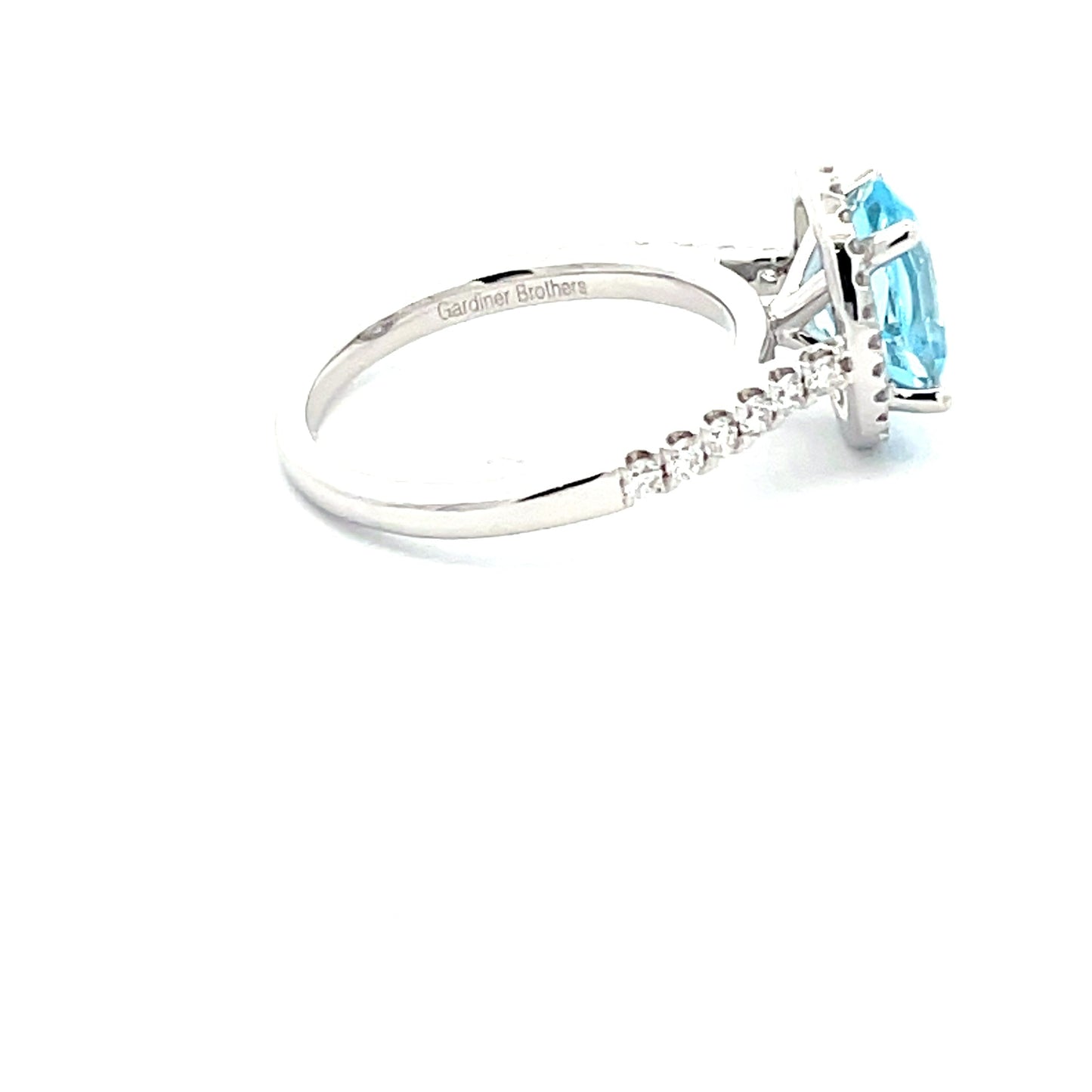 OVAL SHAPED AQUAMARINE AND ROUND BRILLIANT CUT DIAMOND HALO STYLE RING  Gardiner Brothers