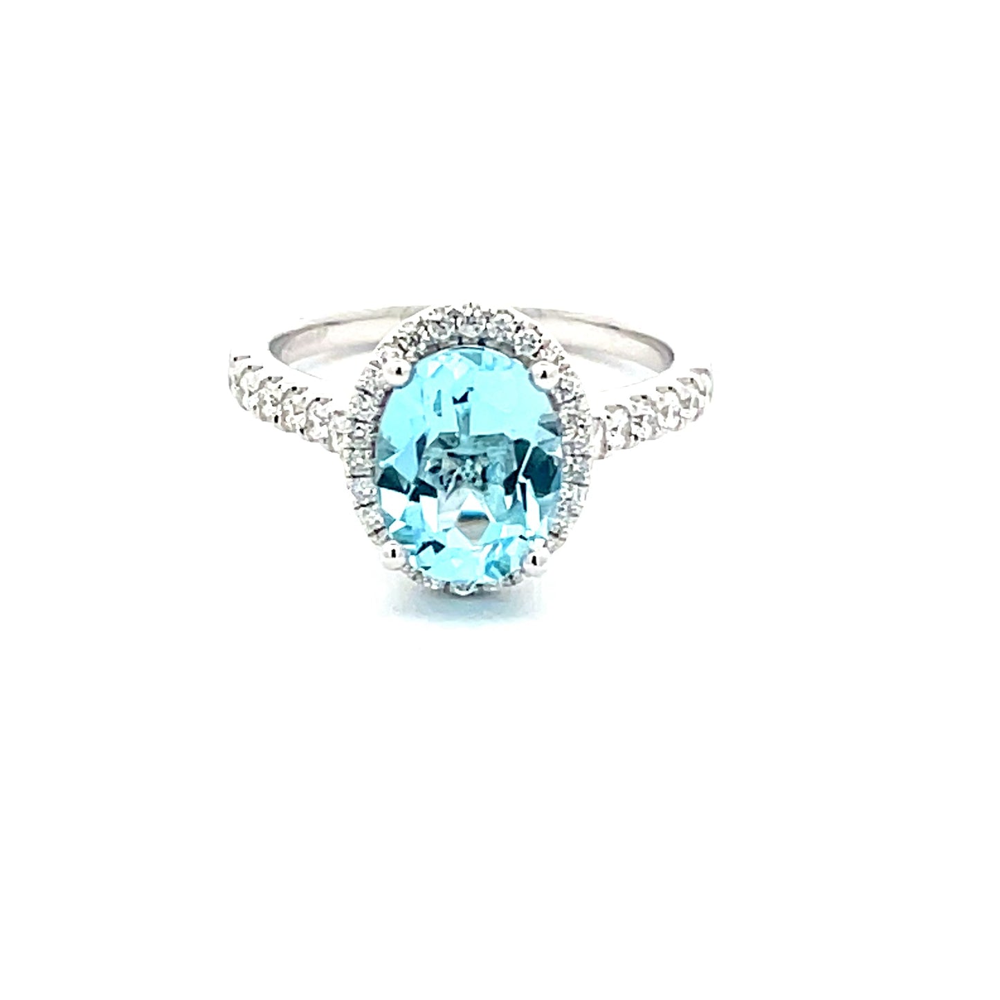 OVAL SHAPED AQUAMARINE AND ROUND BRILLIANT CUT DIAMOND HALO STYLE RING  Gardiner Brothers