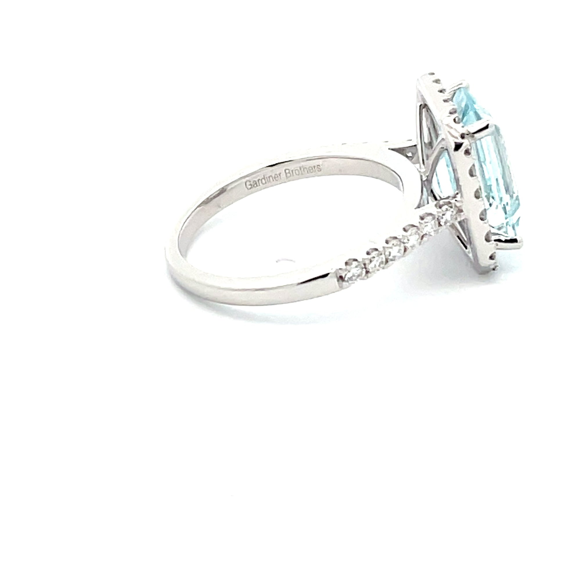 AQUAMARINE AND DIAMOND HALO STYLE RING  Gardiner Brothers