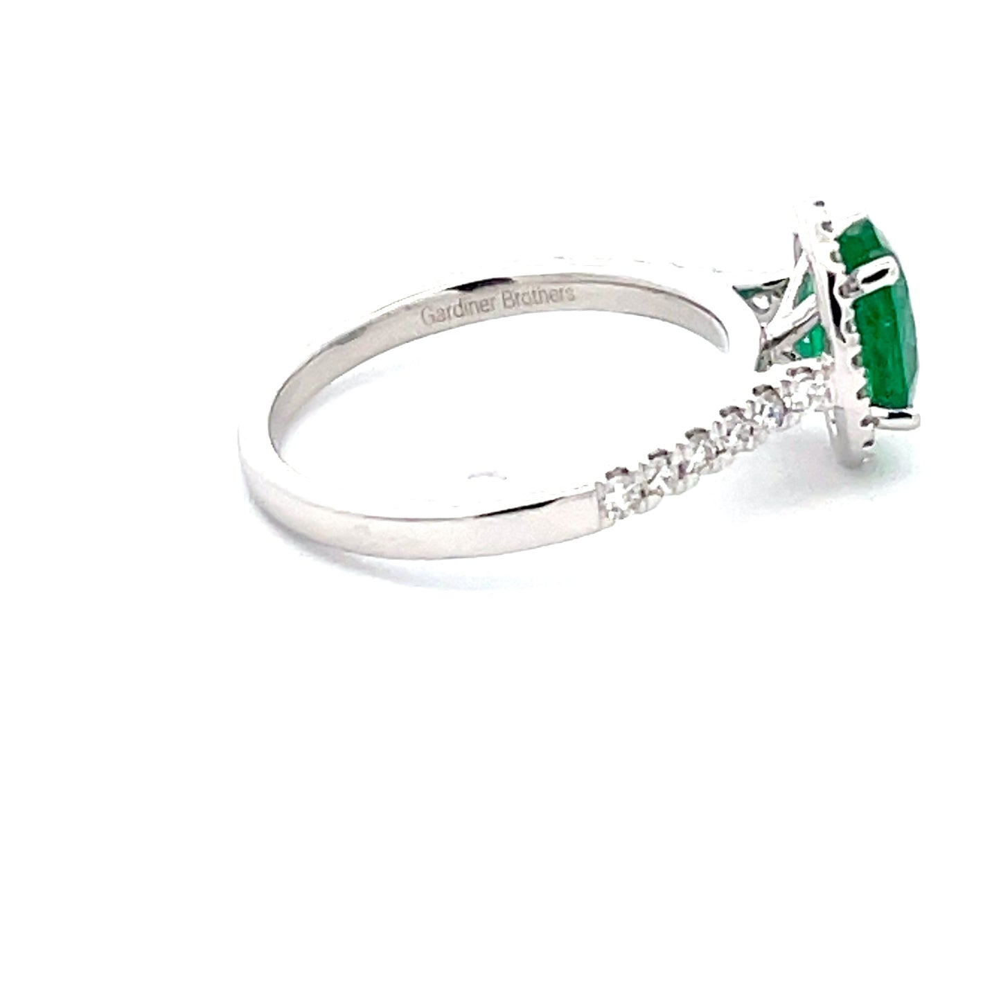 Emerald and round Brilliant Cut diamond halo style ring  Gardiner Brothers