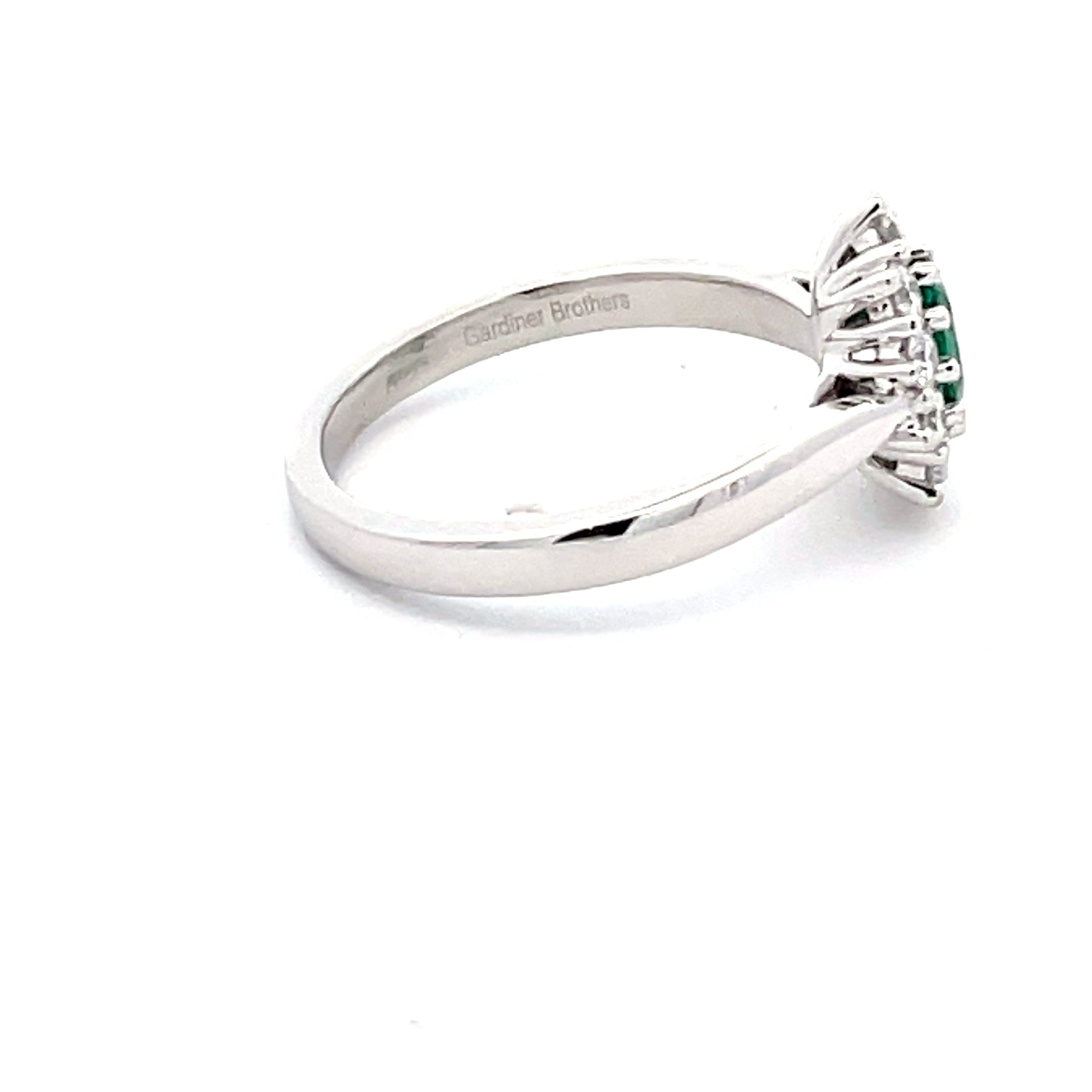 Emerald and round brilliant cut diamond cluster style ring  Gardiner Brothers