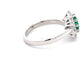 Emerald and round brilliant cut diamond cluster style ring  Gardiner Brothers