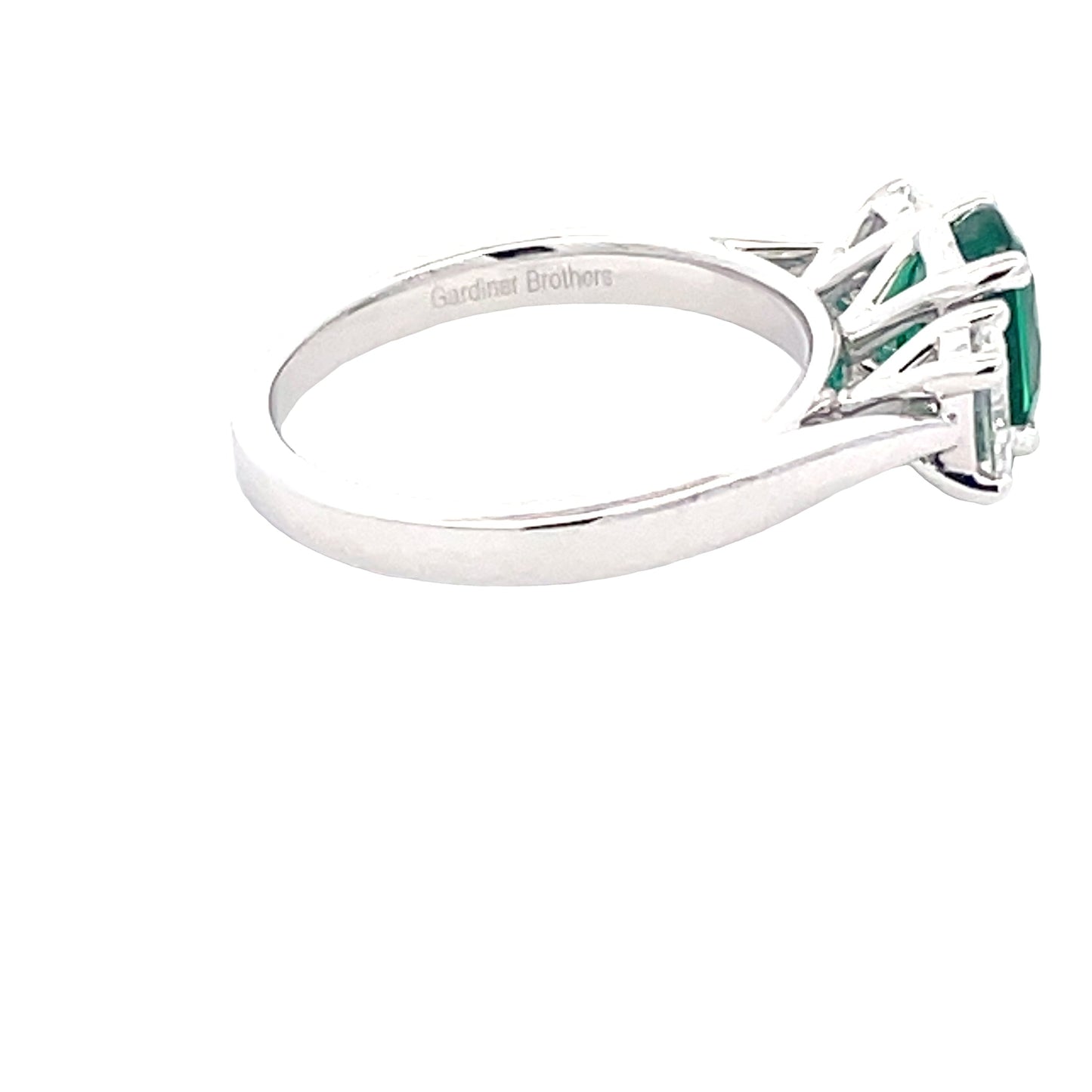 Oval Shaped emerald and oval diamond 3 stone ring