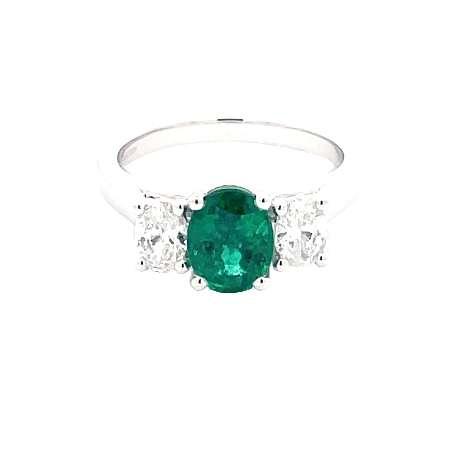 Oval Shaped emerald and oval diamond 3 stone ring