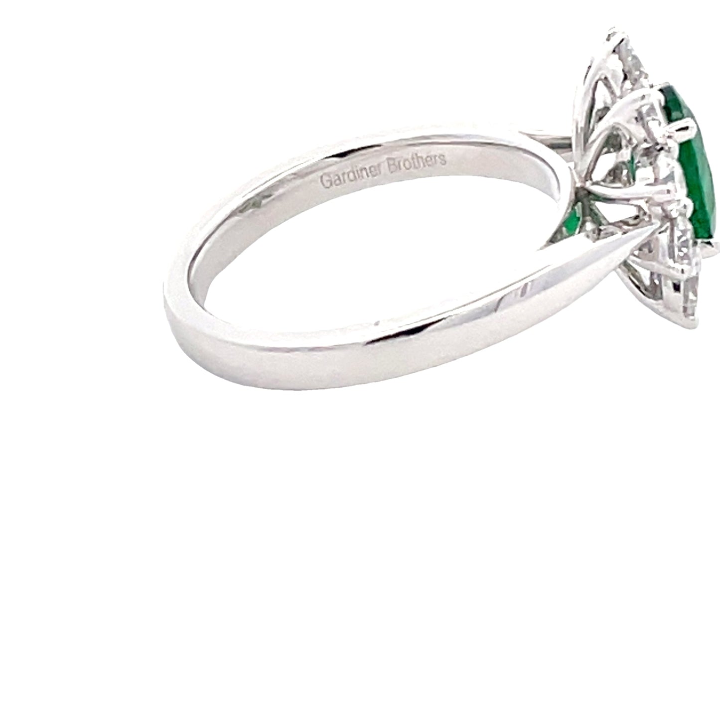 Oval Emerald and Round brilliant cut diamond cluster ring